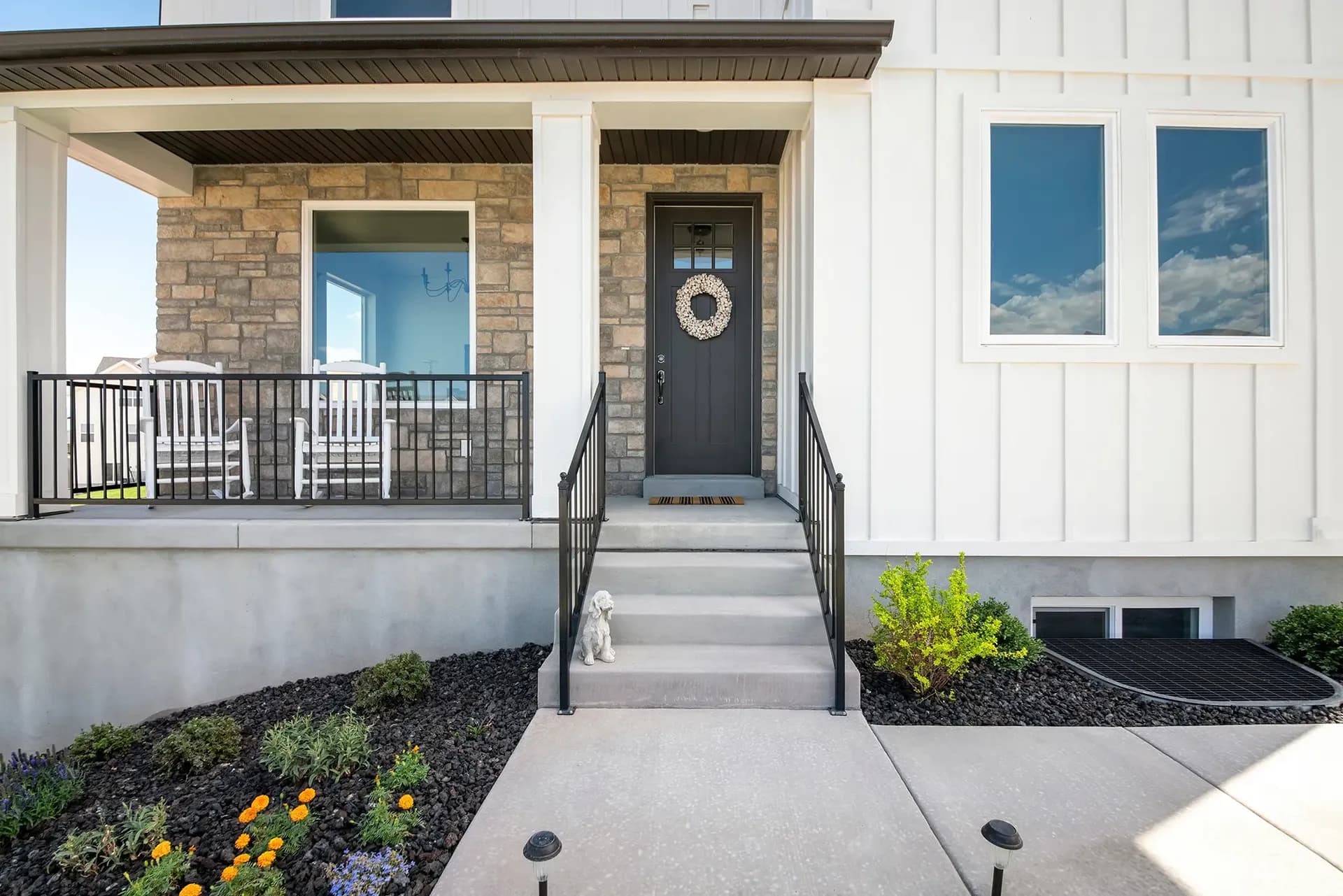Stone Veneer siding on a home alongside board and batten siding.